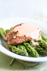 Beef Steak with Sauce on Green Asparagus