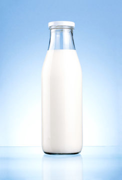 Bottle of fresh milk isolated on a blue background