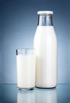 Bottle of fresh milk and a glass isolated on a dark grey backgro