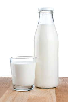 Bottle of fresh milk and glass is wooden table Isolated on white