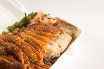 Honey roasted duck in foam box closeup