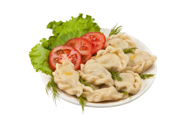Tasty pelmeni with tomato and salad
