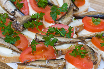 Sandwiches with sprats on a plate