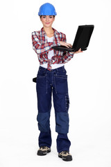 Brunette manual worker holding laptop