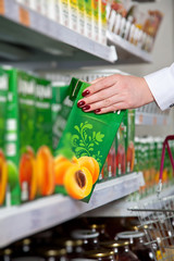 woman hand take box of juice in grocery store