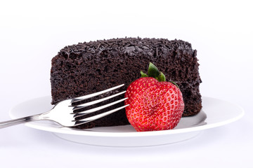 Slice of chocolate cake with strawberries.
