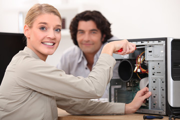 Happy technician fixing a computer