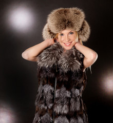portrait of a beautiful blond woman wearing fur coat and hat