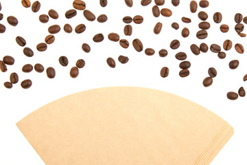 Coffee beans on a coffee filter (white background)