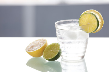 water with lemon and lime in a glass with ice