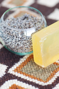 lavender in bowl and soap on ethnic mat