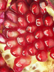 Extreme close up background of a red juicy ripe pomegranate frui