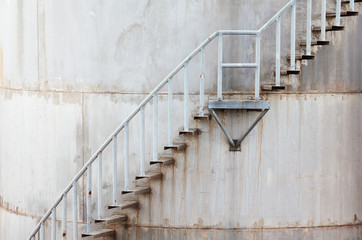Stairway curving up the outside of a large concrete tank