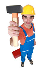 Young mason displaying lump hammer