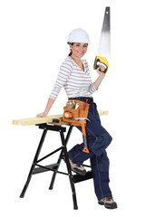 Female carpenter with a saw