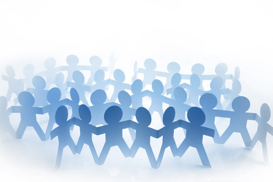 Group of paper chain team members united together in partnership. 