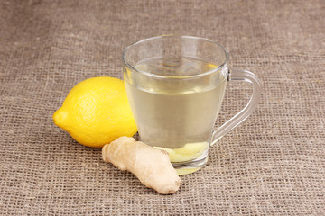 Healthy ginger tea with lemon on sackcloth