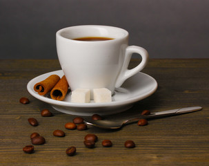 Coffee cup on wooden table on grey background