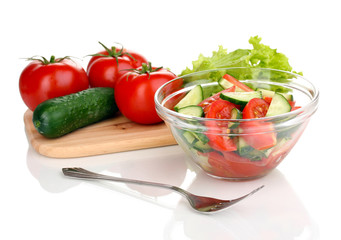 Fresh salad with tomatoes and cucumbers isolated on white