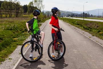 Fototapeta premium Girl and boy biking