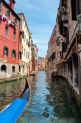 Fototapeta na wymiar Gondola on canal between old houses at Venezia - Italy