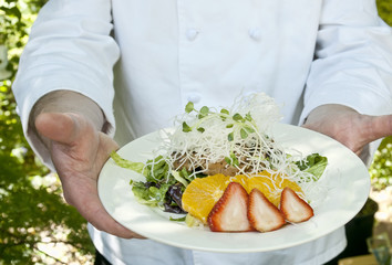 Chef holding dish