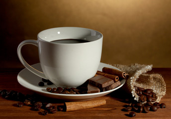 cup of coffee and beans, cinnamon sticks and chocolate
