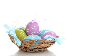Colorful easter eggs in basket isolated on white