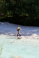Fototapeta na wymiar Fisherman in the Soca river, Slovenia
