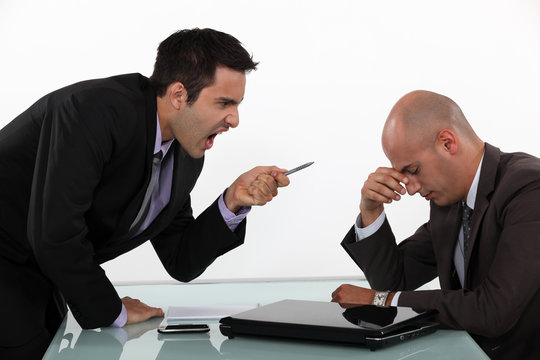 Businessman screaming at a colleague