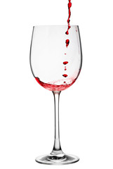 red wine being poured into a wine glass from a height