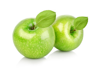 Two green apples with leaves