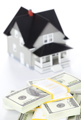 Bundles of dollars in front of house architectural model