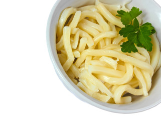 cooked pasta and parsley in a bowl isolated on white background