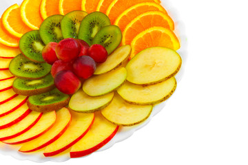 Fototapeta na wymiar Salad apples oranges grapes kiwi fruit slices on a plate isolate