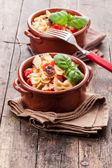 Pasta with cherry tomatoes and olives - wooden table
