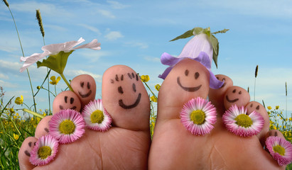 Happy together: Feet on summer meadow