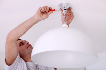 Man fixing ceiling light