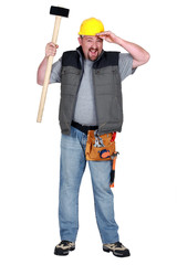 Man with sledge hammer tired after hard day