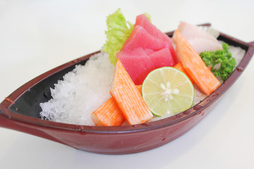 Mix of Japanese sashimi served in a plastic boat
