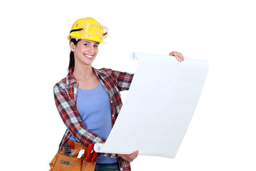 Tradeswoman examining a blueprint