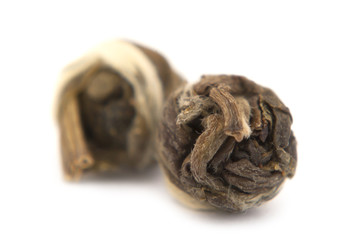 Two pieces of rolled dried jasmine over the white background