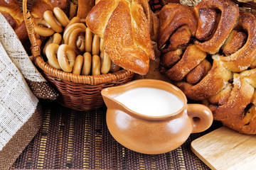 milk in a mug buns and appetizing rolls