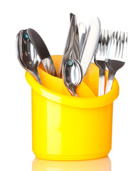Kitchen cutlery, knives, forks and spoons in yellow stand