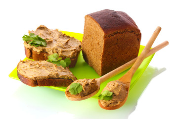 Fresh pate on bread on green plate isolated on white