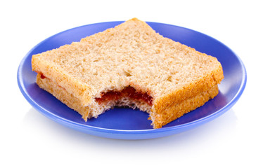 Bitten sandwich with jam on plate isolated on white