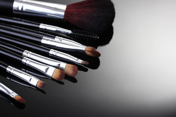 make-up brushes on grey background