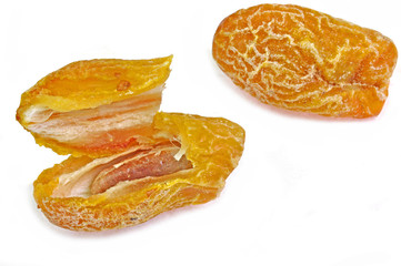 close up of split date palm fruit arranged on white