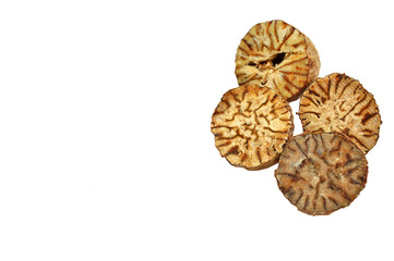 close up of pieces of nutmeg arranged on white background
