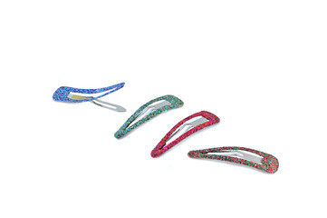 close up of colorful hair clips arranged on white